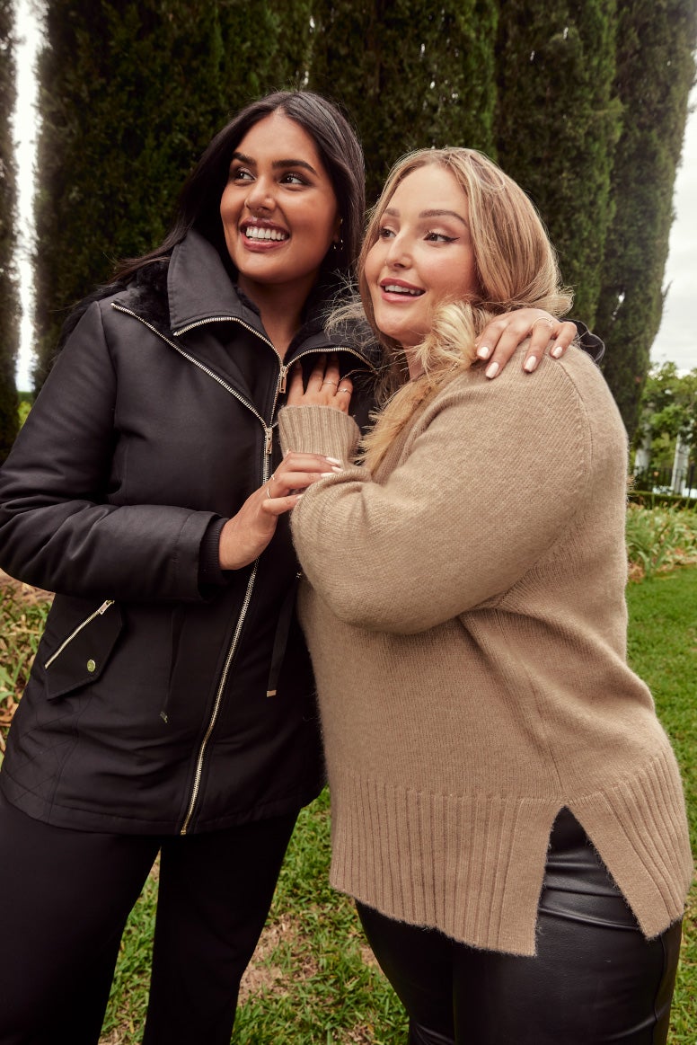 riley hemson and shanaya peters curve models with their arms around each others shoulders in sporty cosy autumn clothing